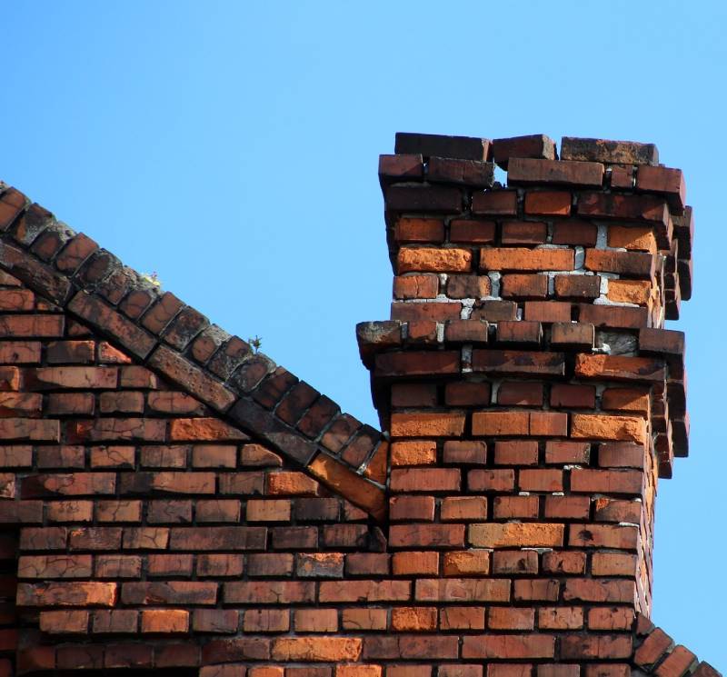 Signs Your Sudbury Home Needs a Chimney Inspection Damaged chimney on an Sudbury home showing cracks and missing mortar